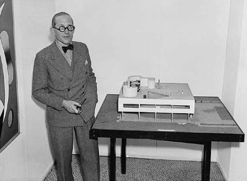 Le Corbusier with an architectural model of his Villa Savoye 