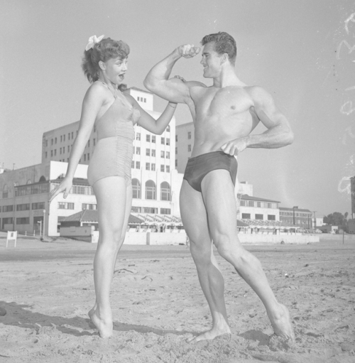Ed Holovchik [aka Ed Fury], bodybuilder and Mr. Los Angeles contestant with model Jackie Coey-- 1953.