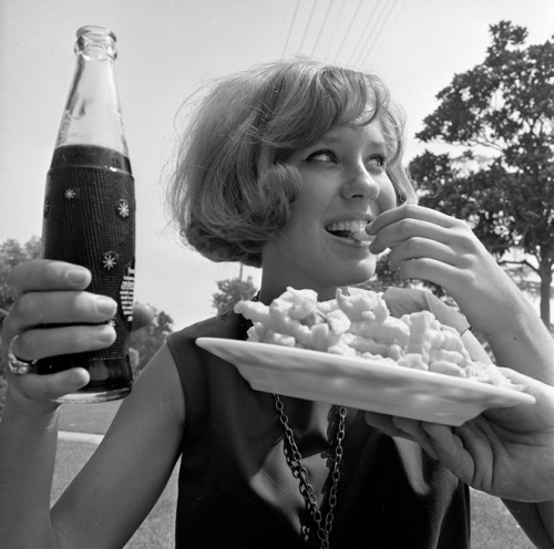 FOOD'S FUN-- Nancy Kennedy, 20, downs diet cola and french fries, popular combination with the young set. The theory is that diet drink saves enough calories to allow for the fattening french fries.  L.A. Times --1965.